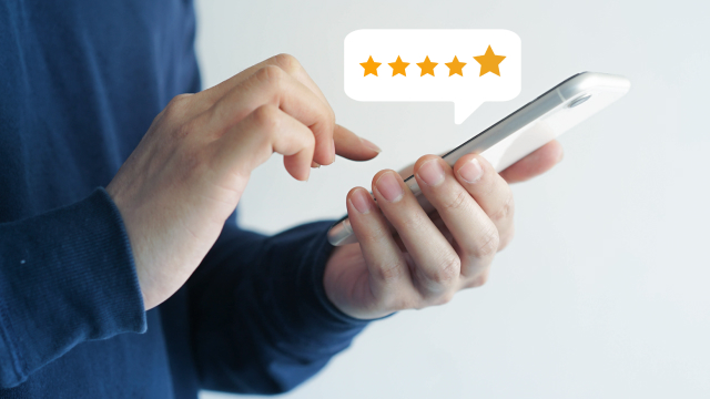 An online customer rating his newly purchased digital product on his smart phone