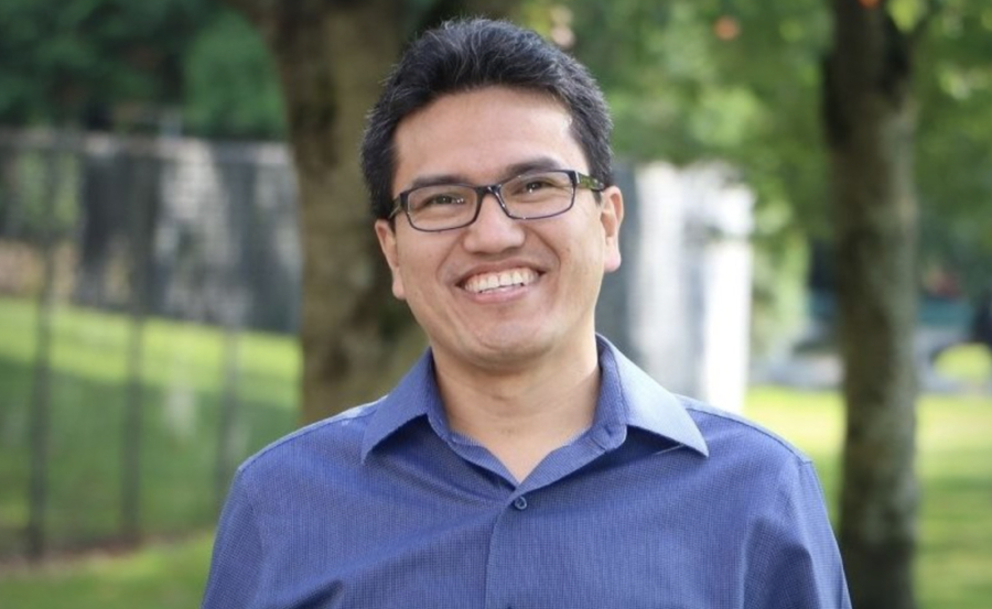 Gonzalo Jimenez in blue button down shirt, smiling.